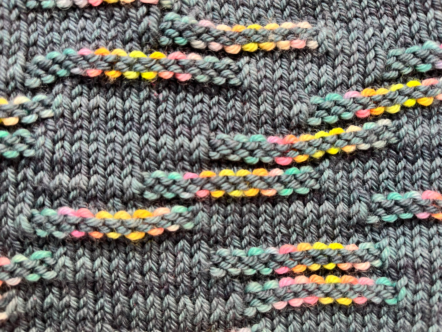 Close up of the Zip Cowl pattern by Helen Reed in M2-9 from the BFL DK Wool collection by the hand dyed yarn expert, The Wool Kitchen.