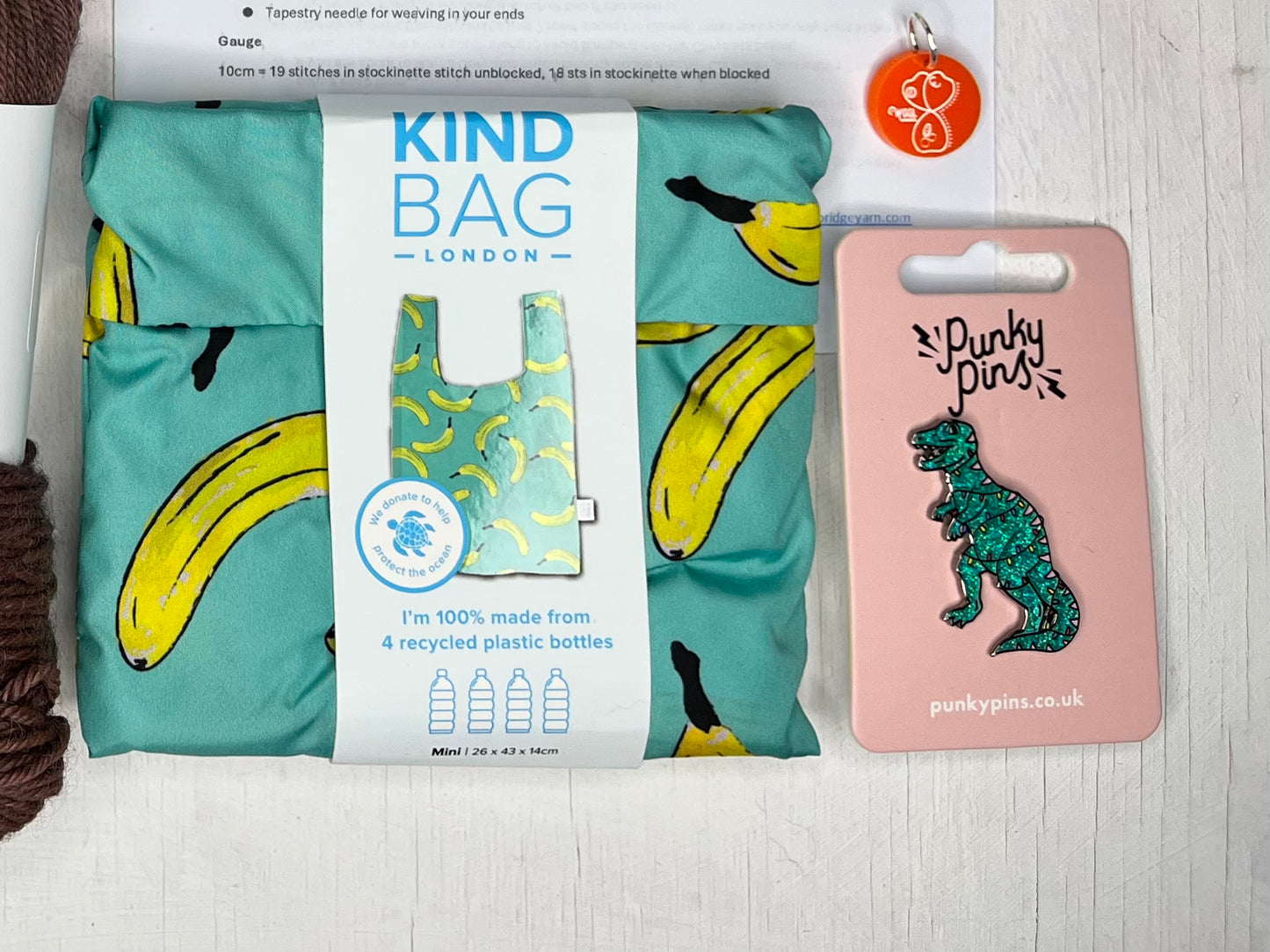 Christmas Punky Pins badge, Kind Bag London mini and an orange stitch marker from the BFL DK Hat in a Tin by the hand dyed yarn expert, The Wool Kitchen.