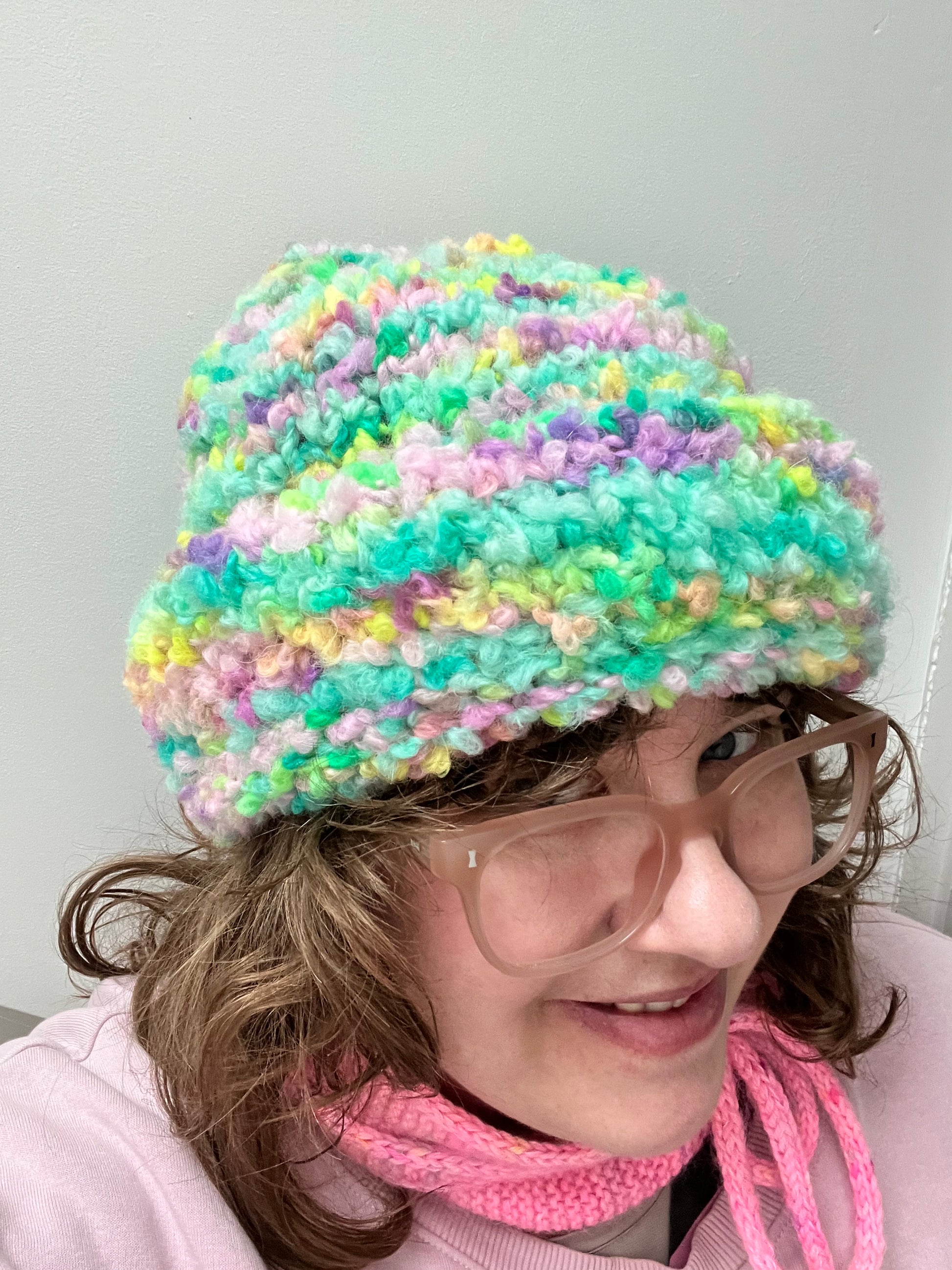 Helen wearing a hat made from Teddy in the Woods from the Chunky Boucle collection by the hand dyed yarn expert, The Wool Kitchen