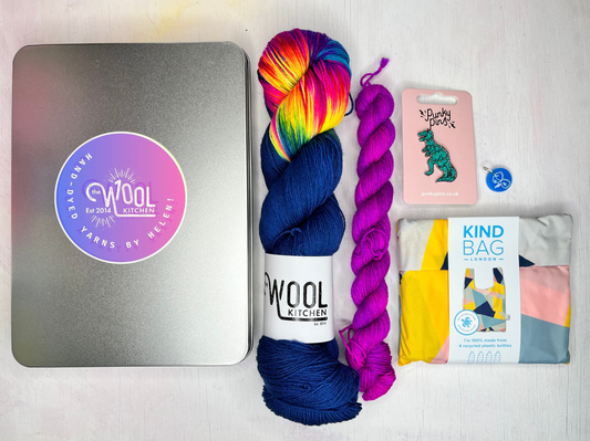 Sock yarn in a tin from the Christmas Gifts collection by the hand dyed yarn expert, The Wool Kitchen. Shown with contrast mini in Woolverine (purple).